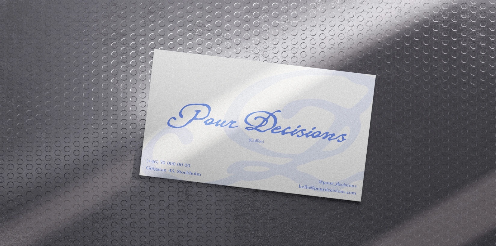 Pour Decisions business card on a dotted metal surface