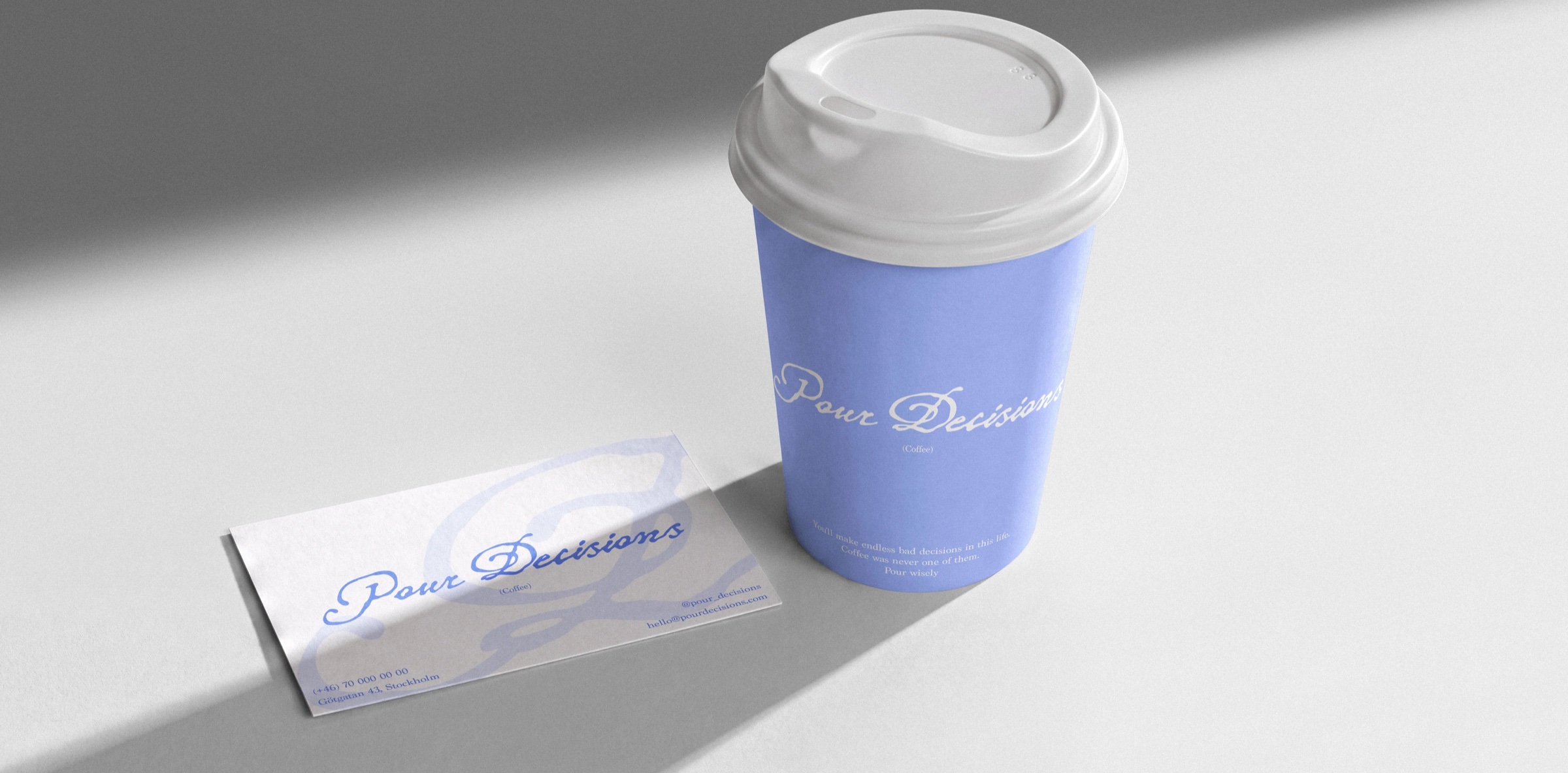 Periwinkle Pour Decisions takeaway cup next to a business card